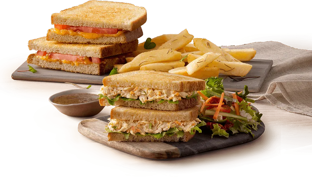 Toasted sandwiches with chips on a wooden board