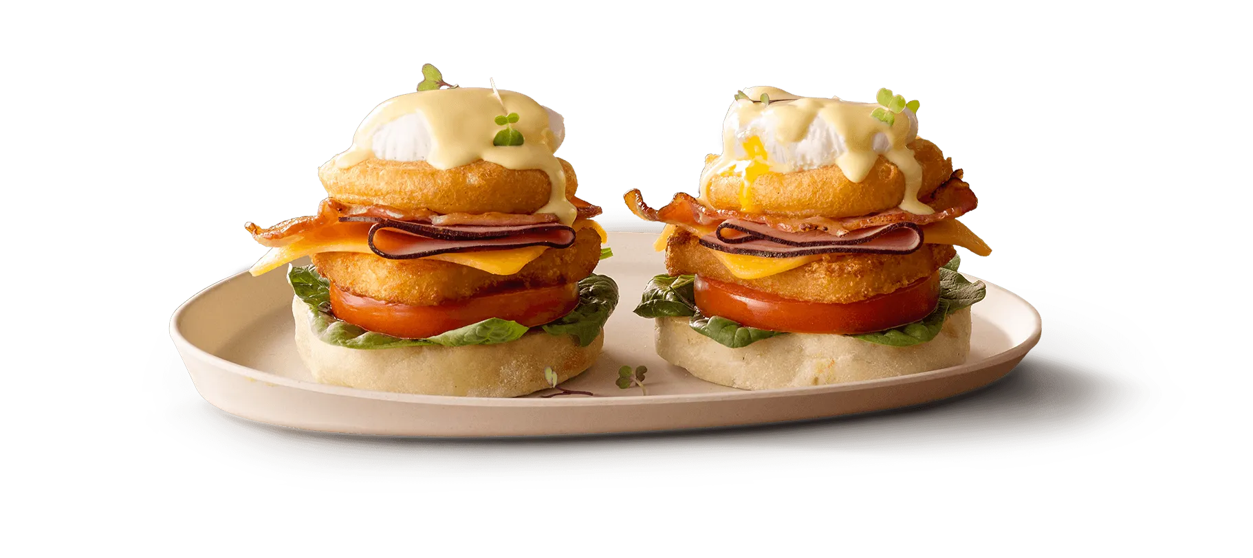 Eggs Benedict with poached eggs, hollandaise sauce, and fresh greens 