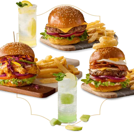  Three burger meals with chips on serving plates with two cool drinks