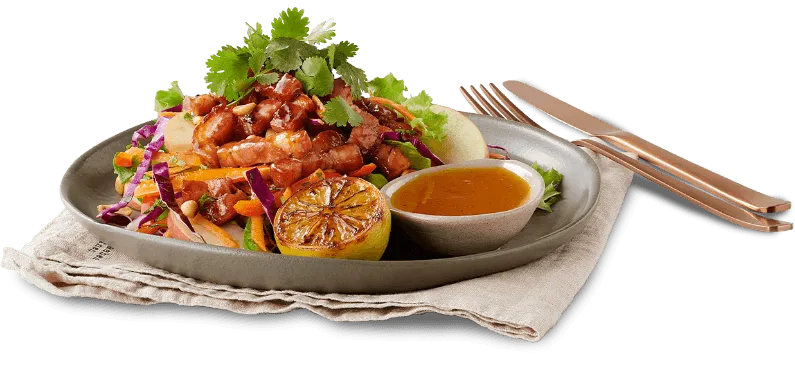 Crispy Pork Salad on plate with utensils alongside