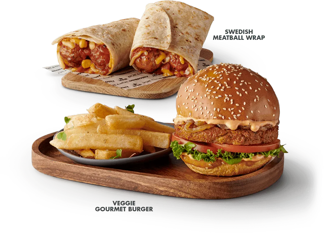 The Veggie burger with a side of chips, served on a wooden board with a wrap in the background