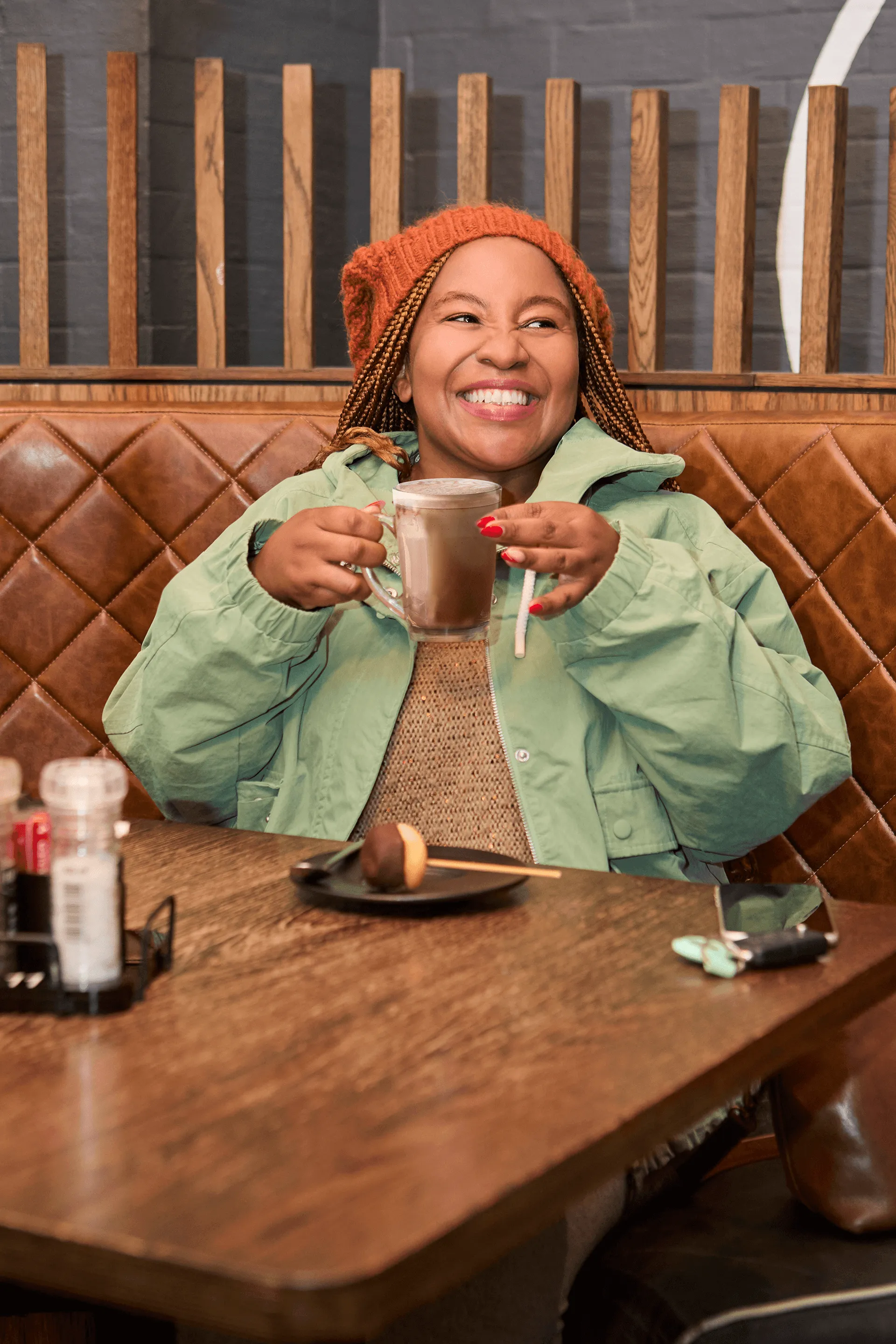 A Lady in Mugg and Bean enjoying a warm drink and dessert side