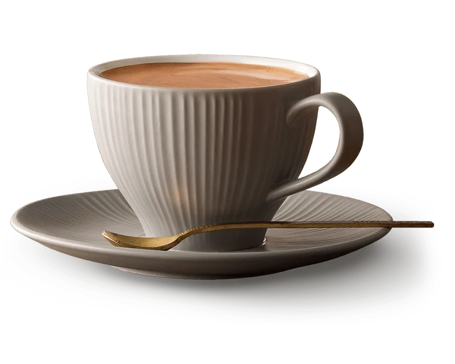 Americano in a cup sitting on a side plate