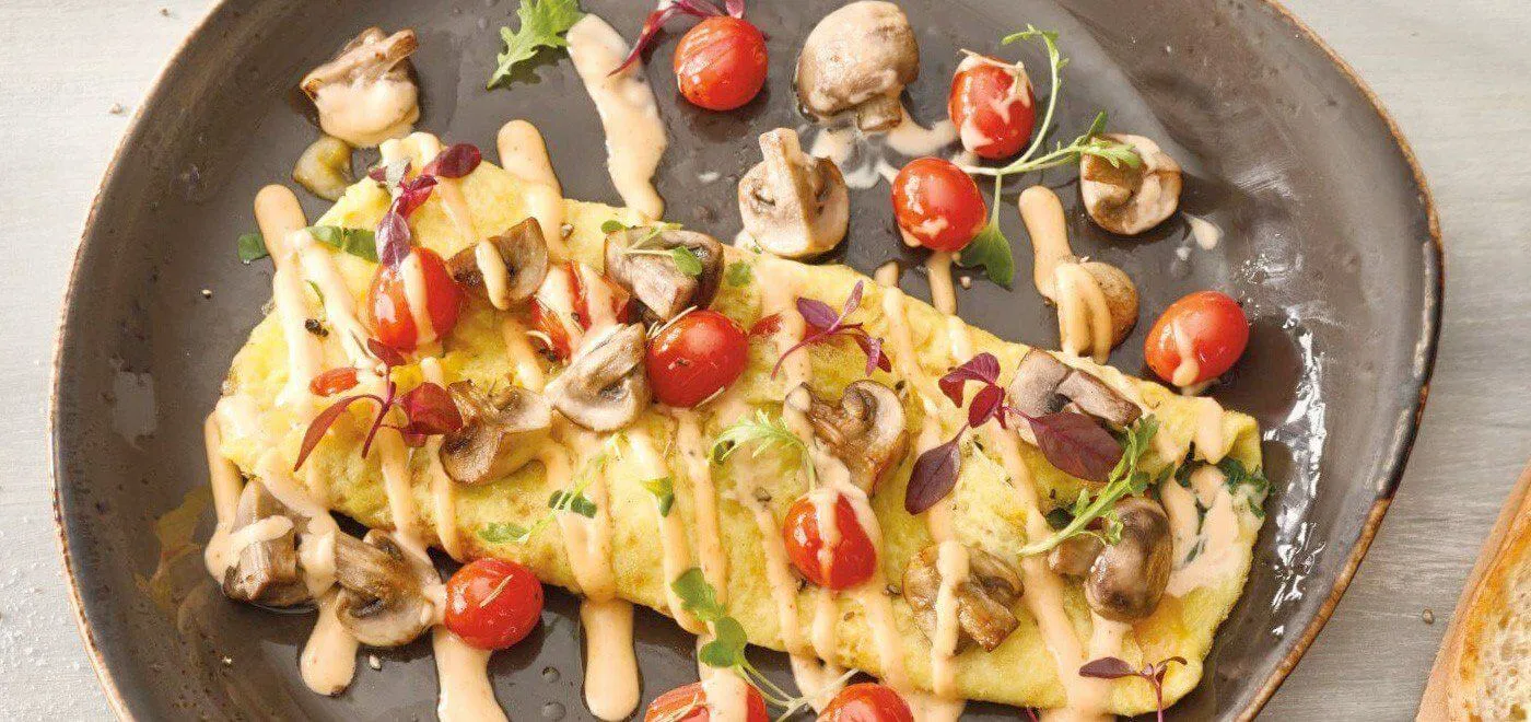 omelette with tomato and drizzle of sauce