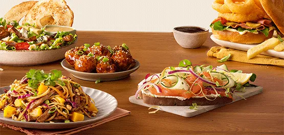A vibrant brunch spread with sandwiches, salads and burgers