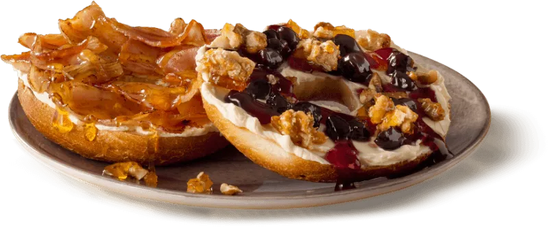 A toasted bagel topped with cream cheese and blueberries