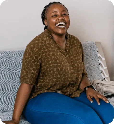 Laughing woman on couch