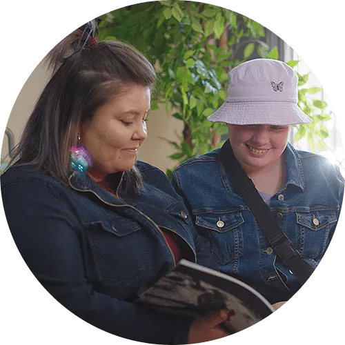 Mom and daughter looking through a book