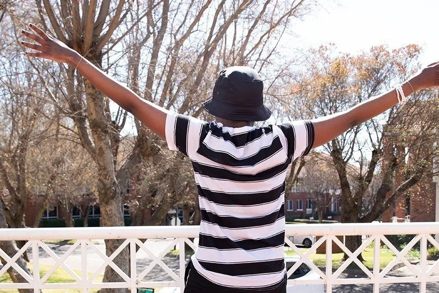 Mpho with her arms stretched out
