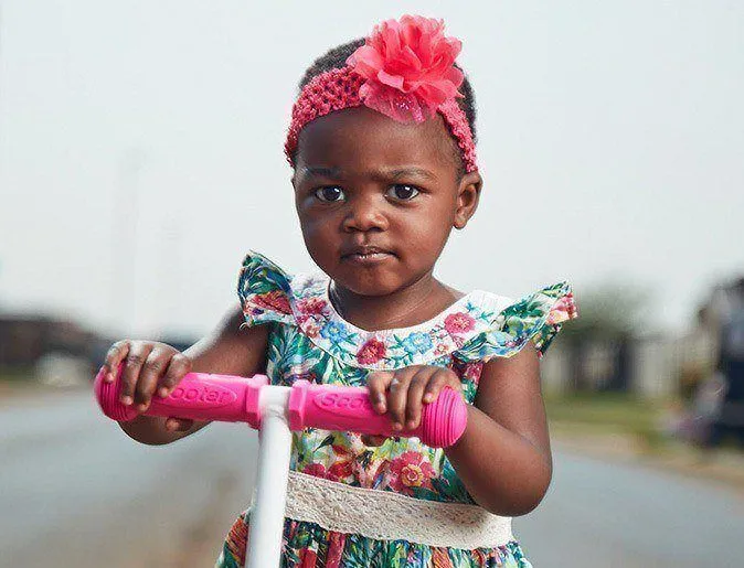 Little girl on a scooter
