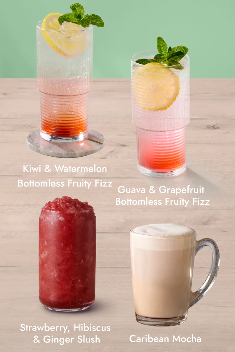 Winter hot and chilled drinks: Caribean Mocha in a glass mug, Guava and Grapefruit Bottomless Fruity Fizz with lemon and mint, Strawberry Hibiscus and Ginger Slush, and Kiwi and Watermelon Bottomless Fruity Fizz on a wooden surface.